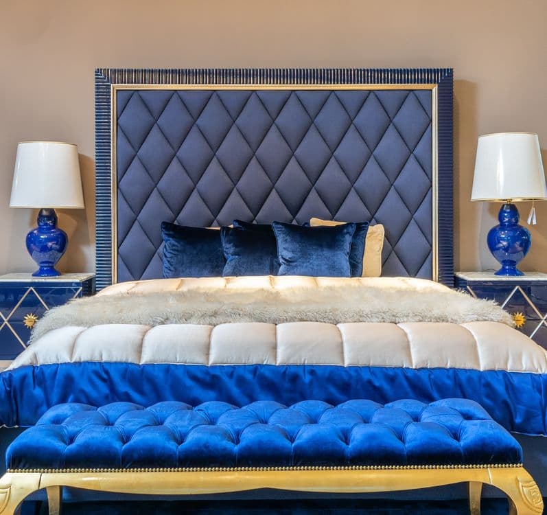 Elegant bedroom with tufted headboard and blue accents