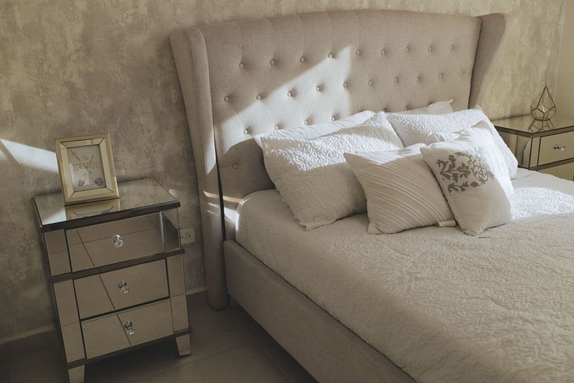 Luxurious tufted bed headboard in modern bedroom