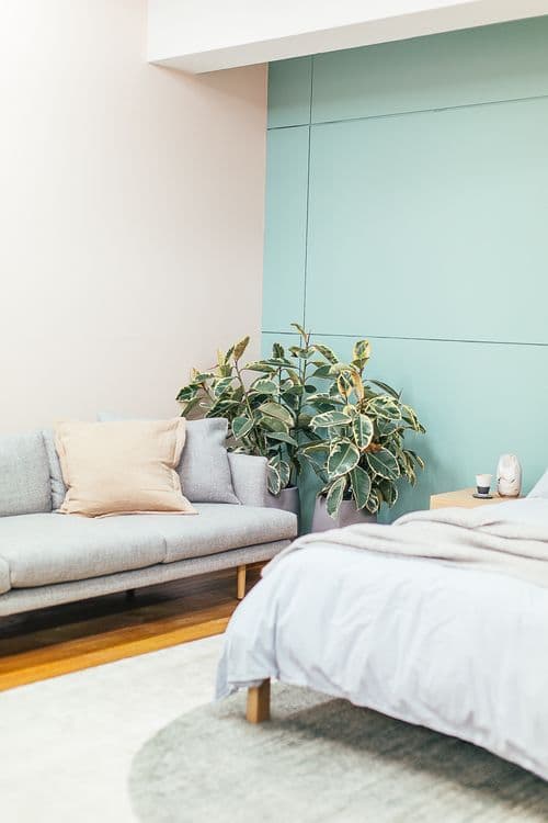 Minimalist bedroom with wooden bed frame and warm lighting
