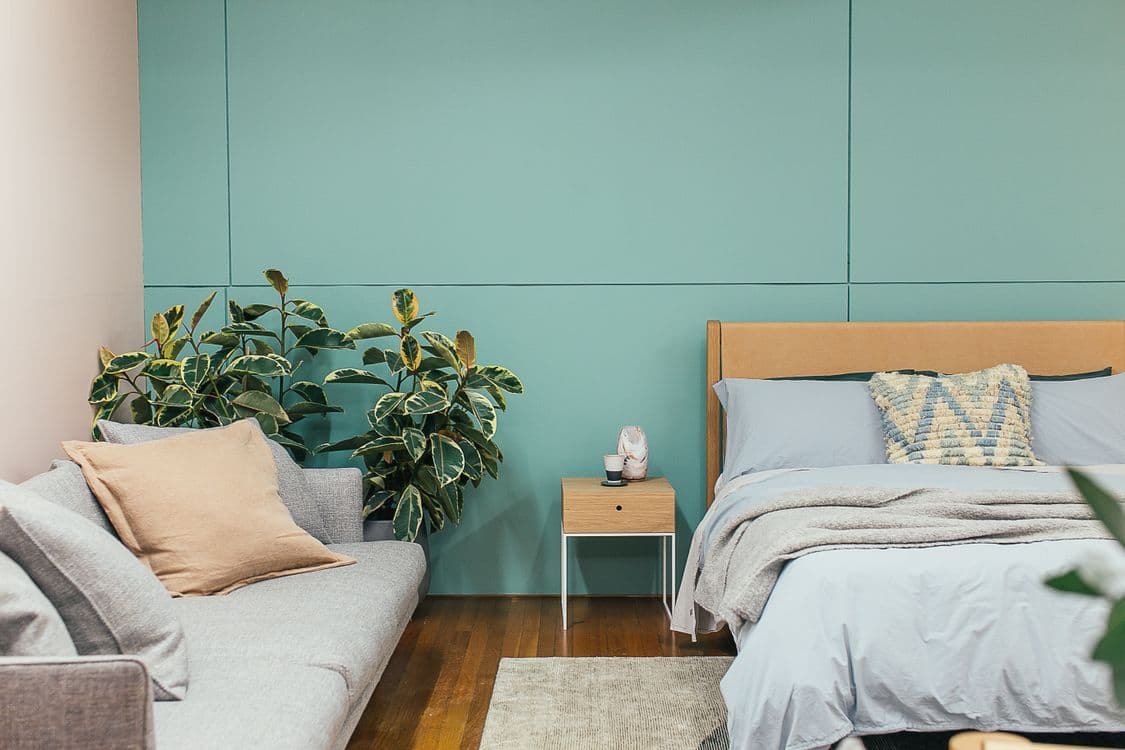 Cozy bedroom with mahogany bed and indoor plants