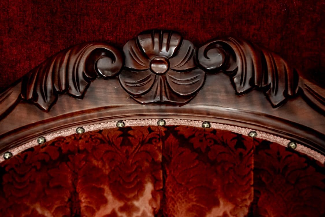 Close-up of carved wood detail on mahogany headboard