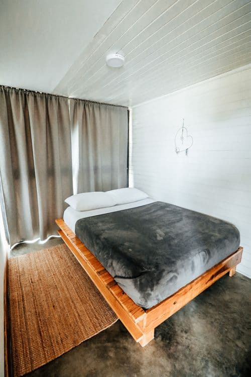 Serene bedroom with wooden bed frame and soft lighting